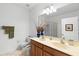 Well-lit bathroom with double sinks, a large mirror, and a shower-tub combination at 5509 Florence Harbor Dr, Orlando, FL 32829