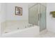 Bright bathroom with a jacuzzi tub, glass enclosed shower, and tile flooring at 5509 Florence Harbor Dr, Orlando, FL 32829