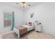Cozy bedroom with neutral tones features a single bed and tile floors, with natural light from a window at 5509 Florence Harbor Dr, Orlando, FL 32829