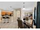 Open concept dining area with modern table, tile flooring, and view to kitchen and living room at 5509 Florence Harbor Dr, Orlando, FL 32829