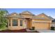 Beautiful exterior view of the home with a well-manicured lawn and a two-car garage with a neutral color scheme at 5509 Florence Harbor Dr, Orlando, FL 32829