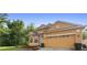 Charming single-Gathering home featuring a well-maintained lawn, neutral-colored exterior, and a spacious two-car garage at 5509 Florence Harbor Dr, Orlando, FL 32829