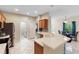 Bright kitchen featuring tile floors, stainless steel appliances and breakfast bar overlooking a dining area at 5509 Florence Harbor Dr, Orlando, FL 32829