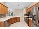 Bright kitchen with stainless steel appliances, light wood cabinets and mosaic tile backsplash at 5509 Florence Harbor Dr, Orlando, FL 32829