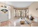 A cozy living room featuring tile floors, comfortable seating, and natural light from large windows at 5509 Florence Harbor Dr, Orlando, FL 32829