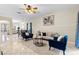 Open living area featuring tiled floors, modern furniture, and a view into the dining room at 5509 Florence Harbor Dr, Orlando, FL 32829