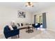 Bright living room features stylish furniture, ceiling fan, and sliding glass doors with decorative blue curtains at 5509 Florence Harbor Dr, Orlando, FL 32829