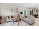 Inviting living room features neutral furnishings, stylish decor, tile floors, and ample natural light from a large window at 5509 Florence Harbor Dr, Orlando, FL 32829