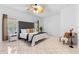 Spacious main bedroom with a tufted headboard, tile floors, and natural light from a window at 5509 Florence Harbor Dr, Orlando, FL 32829