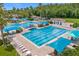 Aerial view of a large pool area with lap lanes, lounge chairs, and shade cabanas at 5509 Florence Harbor Dr, Orlando, FL 32829