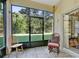 Inviting screened porch with slate tile flooring and views of the lush green backyard at 5509 Florence Harbor Dr, Orlando, FL 32829