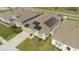An aerial view of a home with solar panels, manicured landscaping, and a long driveway at 5637 Cedar Chase Dr, St Cloud, FL 34771