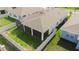 Aerial view of fenced backyard, screened lanai with brown roof and green grass at 5637 Cedar Chase Dr, St Cloud, FL 34771
