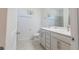 Bathroom with double vanity, white cabinetry and neutral tile flooring at 5637 Cedar Chase Dr, St Cloud, FL 34771