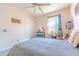 Cozy bedroom featuring fan, closet, and small workspace near the bright window at 5637 Cedar Chase Dr, St Cloud, FL 34771
