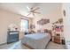 Comfortable bedroom with ceiling fan, dresser and shelving for personalized decor at 5637 Cedar Chase Dr, St Cloud, FL 34771