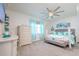 Bright bedroom with a gray bed frame, gray dresser and accent decor, and plush carpet at 5637 Cedar Chase Dr, St Cloud, FL 34771