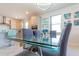 Dining area with glass table, gray chairs, modern lighting, and views into the kitchen at 5637 Cedar Chase Dr, St Cloud, FL 34771