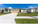 Charming single-story home with a well-manicured lawn, long driveway and a two-car attached garage at 5637 Cedar Chase Dr, St Cloud, FL 34771