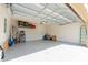 Spacious garage with epoxy flooring and overhead storage racks for added convenience at 5637 Cedar Chase Dr, St Cloud, FL 34771