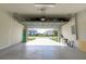 Well-lit garage with epoxy flooring and view to the street for easy access at 5637 Cedar Chase Dr, St Cloud, FL 34771