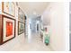 Inviting hallway featuring art-lined walls and a decorative stone accent wall at 5637 Cedar Chase Dr, St Cloud, FL 34771