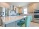 Modern kitchen with stainless steel appliances, gray cabinets, tile backsplash and quartz countertop island with seating at 5637 Cedar Chase Dr, St Cloud, FL 34771