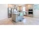 Modern kitchen featuring white cabinets, stainless steel appliances, and an island with bar seating at 5637 Cedar Chase Dr, St Cloud, FL 34771