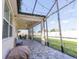 Relaxing screened-in lanai featuring slate tile flooring, ceiling fans and strung patio lights at 5637 Cedar Chase Dr, St Cloud, FL 34771