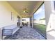 Inviting screened-in lanai with gray stone tile, contemporary outdoor furniture, and open views of the yard at 5637 Cedar Chase Dr, St Cloud, FL 34771