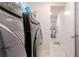 Convenient laundry room with modern appliances near a well-lit hallway at 5637 Cedar Chase Dr, St Cloud, FL 34771