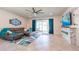 Open living room featuring tile floors, gray sofa and a glass sliding door to the patio at 5637 Cedar Chase Dr, St Cloud, FL 34771