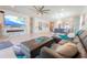 Open living room with tile floors, gray sofa, modern fireplace feature and views to dining area at 5637 Cedar Chase Dr, St Cloud, FL 34771
