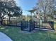 Community playground featuring modern play equipment in fenced in area and providing a safe and fun environment for children at 5637 Cedar Chase Dr, St Cloud, FL 34771