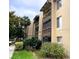 Multi-story condo building with balconies and well-maintained landscaping, offering a serene living environment at 586 Orange Dr # 114, Altamonte Springs, FL 32701