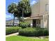 Attractive condo building featuring well-maintained landscaping with mature trees and shrubs at 586 Orange Dr # 114, Altamonte Springs, FL 32701