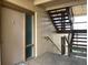 Hallway with door and stairs leading to upper level apartment homes at 586 Orange Dr # 114, Altamonte Springs, FL 32701