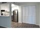 A functional kitchen is shown with white cabinetry and stainless steel appliances, next to a utility closet at 586 Orange Dr # 114, Altamonte Springs, FL 32701