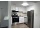 A functional kitchen is shown with white cabinetry, stainless steel appliances, and a modern microwave at 586 Orange Dr # 114, Altamonte Springs, FL 32701