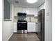 A functional kitchen is shown with white cabinetry, stainless steel appliances, and a modern microwave at 586 Orange Dr # 114, Altamonte Springs, FL 32701