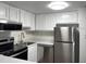 The efficient kitchen features white cabinetry, stainless steel appliances, and lots of natural light at 586 Orange Dr # 114, Altamonte Springs, FL 32701