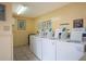 On-site laundry room with multiple washers and dryers for residents' convenience at 586 Orange Dr # 114, Altamonte Springs, FL 32701
