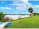 Lake view from a grassy lawn with kayaks at 586 Orange Dr # 114, Altamonte Springs, FL 32701
