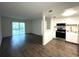 Modern living space with wood flooring and a kitchen featuring stainless steel appliances at 586 Orange Dr # 114, Altamonte Springs, FL 32701