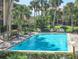 Community pool with ladder and chairs, surrounded by landscaping and community buildings at 586 Orange Dr # 114, Altamonte Springs, FL 32701