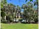 Swimming pool in the community, surrounded by Palm trees and green landscaping at 586 Orange Dr # 114, Altamonte Springs, FL 32701