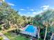 Aerial view of community pool surrounded by manicured landscaping and tall palm trees at 586 Orange Dr # 114, Altamonte Springs, FL 32701