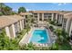 Aerial view of the community swimming pool, with sun loungers for relaxing in the sun at 586 Orange Dr # 114, Altamonte Springs, FL 32701
