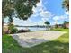 Lakeside sand volleyball court and kayaks viewed from the grass at 586 Orange Dr # 114, Altamonte Springs, FL 32701