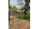 View of the screen-enclosed pool area surrounded by lush foliage and landscaping at 612 Wolf Run, Winter Haven, FL 33880